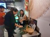 Three Hub members interactive with items in a display of props including large leaves and pieces of native flora, traditionally made bowls, a traditional fishing net, and an image of traditional fishing methods thumbnail